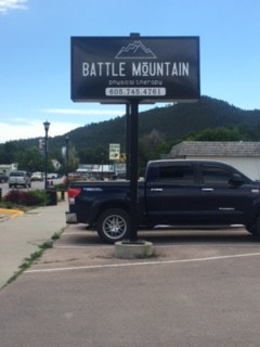 Battle Mountain Physical Therapy street sign with the phone number